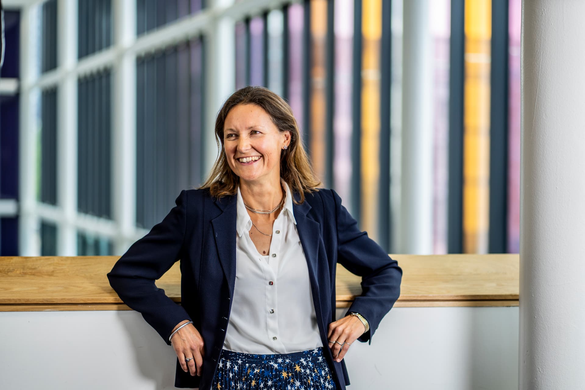 Katy Tuncer smiling in a navy blazer